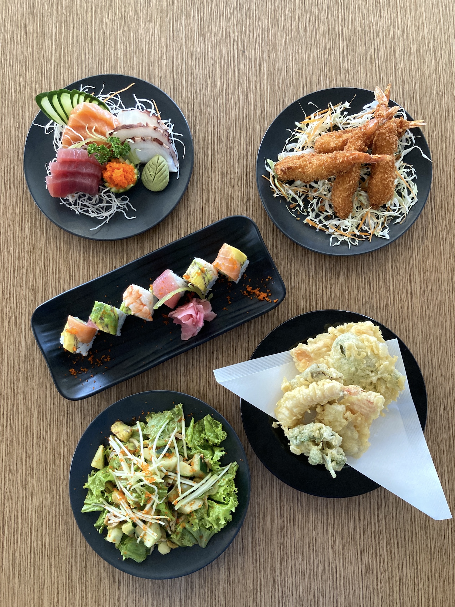 A sample of Gureisu Okawari's diverse menu—from sashimi and salads to sushi and temaki wraps