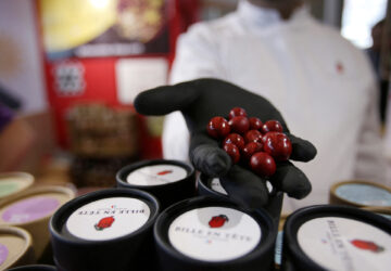 French chocolatier Damien Vidal poses with chocolates flavored with Carolina Reaper chilli pepper at the Paris Chocolate fair in Paris, France