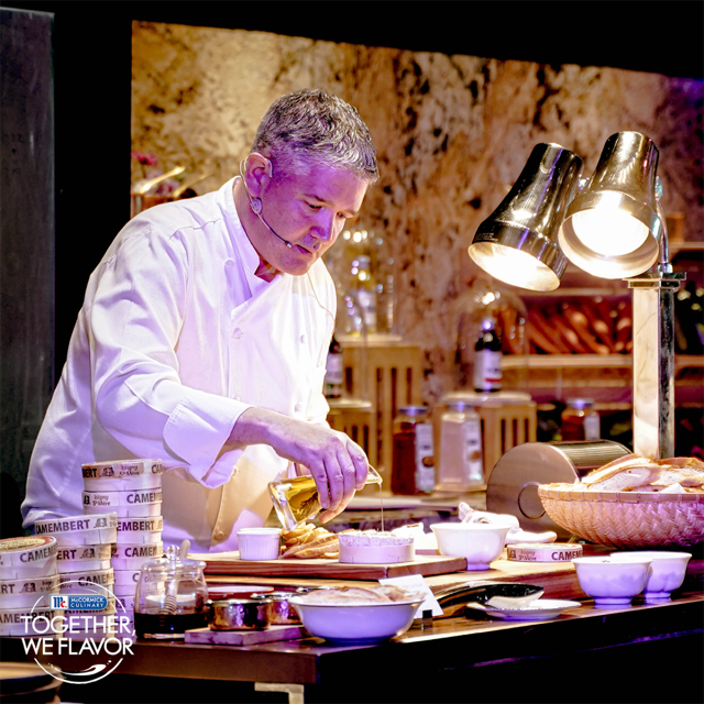 Chef Mark Hagan crafting the Camembert Au Four that also uses McCormick’s parsley flakes and rosemary at the Together, We Flavor event