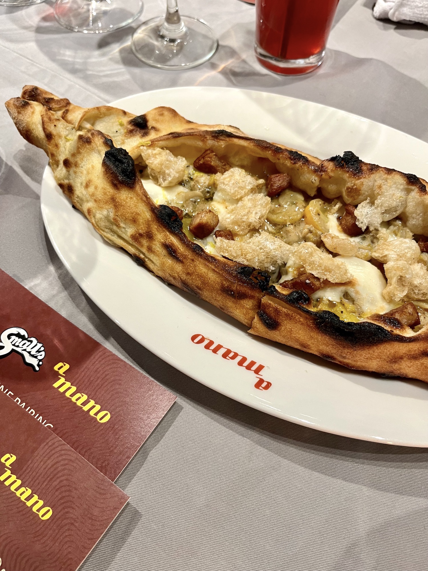 Small's and A Mano collab: Pizza with garlic, clams, pork crisps, and yellow tomatoes
