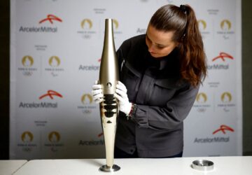 FILE PHOTO: Employee Camille Eudeline holds a torch for the Paris 2024 Olympic and Paralympic Games, manufactured by ArcelorMittal, world leader in steel and Official Partner of the Games, during a press visit at the Guy Degrenne factory in Vire, France, November 17, 2023. REUTERS/Stephane Mahe/File Photo